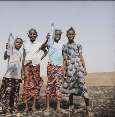 Children collecting safe water from purification units